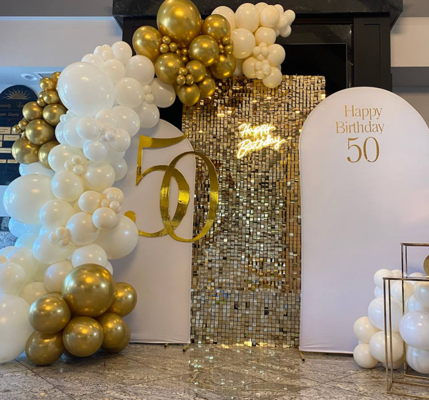 “Premium photo zone with white and gold balloons, shining gold mosaic and the inscription ‘Happy Birthday 50’